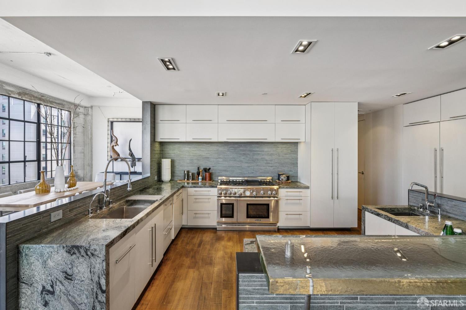 6 Mint Plaza, Unit 900A San Francisco, CA 94103 - Photo 17 of 55 a large kitchen with stainless steel appliances granite countertop a stove a sink and a granite counter tops