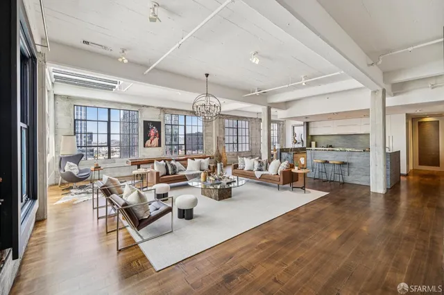 a living room with lots of furniture and wooden floor