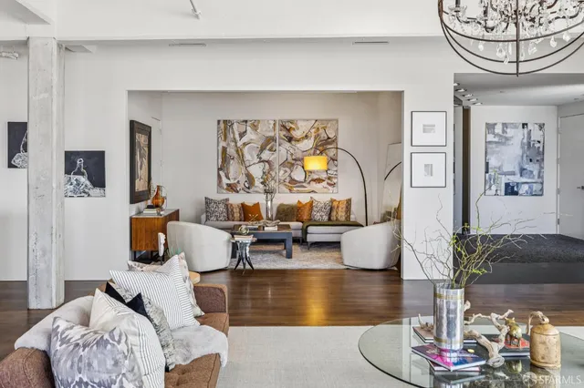 a living room with furniture and a potted plant