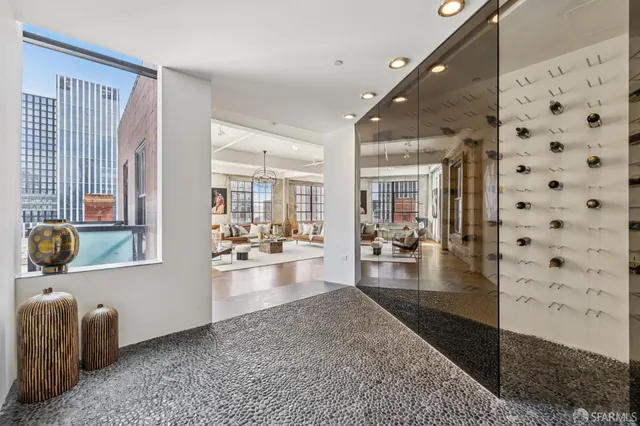 a hallway with a couch and chandelier