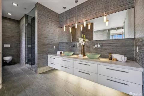 an entryway with wooden floor and cabinets