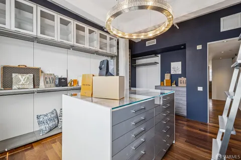 a bedroom with a bed and large windows