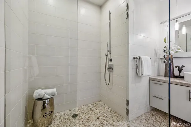 a bathroom with a sink a toilet and shower