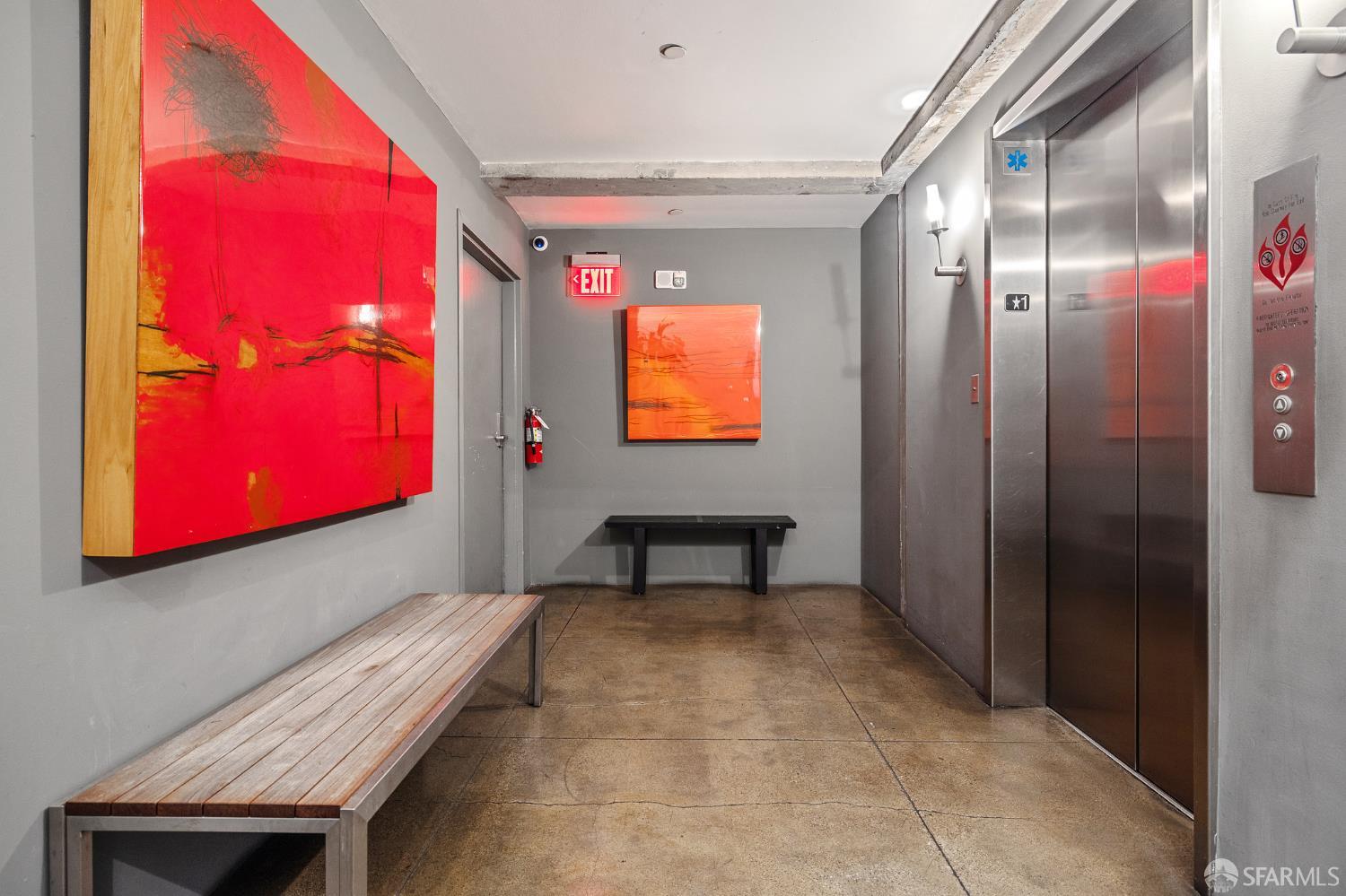 6 Mint Plaza, Unit 900A San Francisco, CA 94103 - Photo 52 of 55 a hallway with a elevator and a painting on the wall