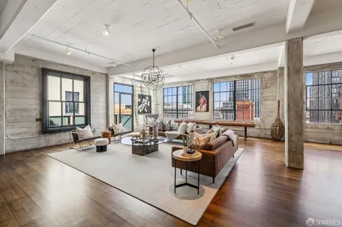a living room with furniture chandelier and a large window