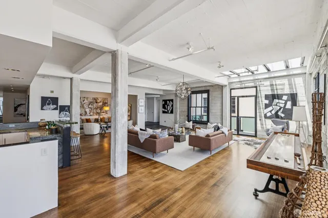 a living room with furniture chandelier and a large window