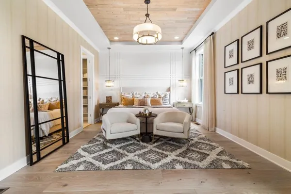 a living room with furniture windows and a chandelier
