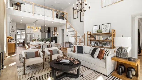 a living room with furniture and a chandelier