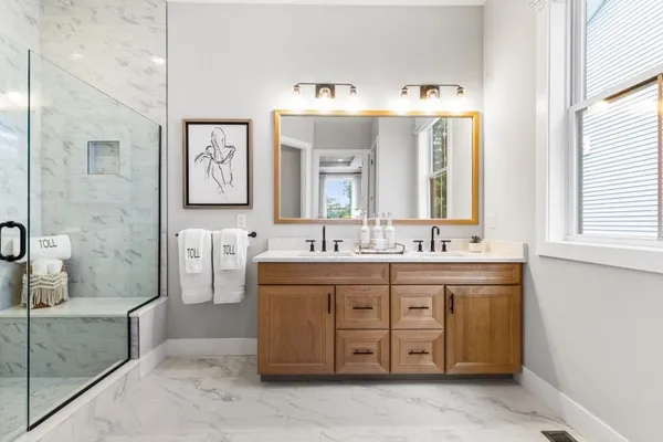 a spacious bathroom with a double vanity sink mirror and double