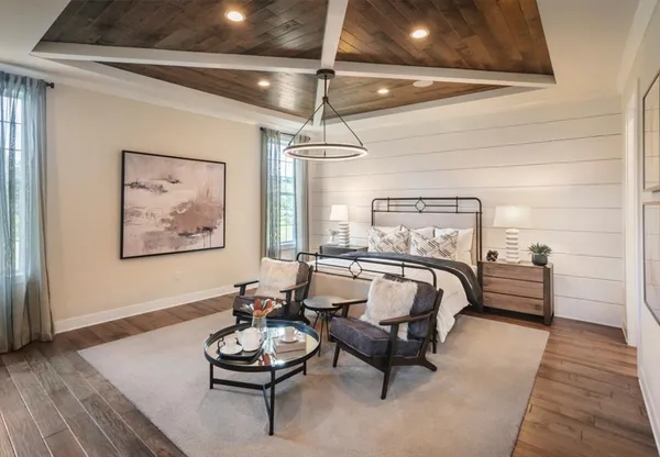 a bedroom with furniture and a wooden floor
