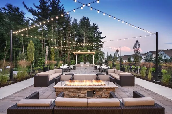 a view of a patio with couches chairs and a fire pit