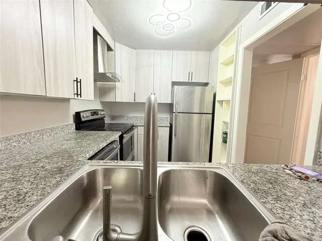 a kitchen with a refrigerator and a sink