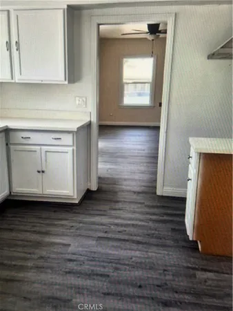 a room with wooden floor and cabinets