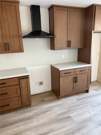a kitchen with a cabinets and wooden floor