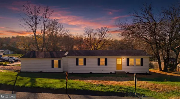 a view of house with a yard