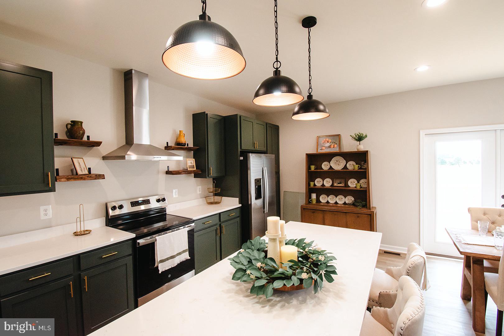 362 Drummer Hill Road Front Royal, VA 22630 - Photo 15 of 48 a kitchen with stainless steel appliances a sink a stove a refrigerator a dining table and chairs