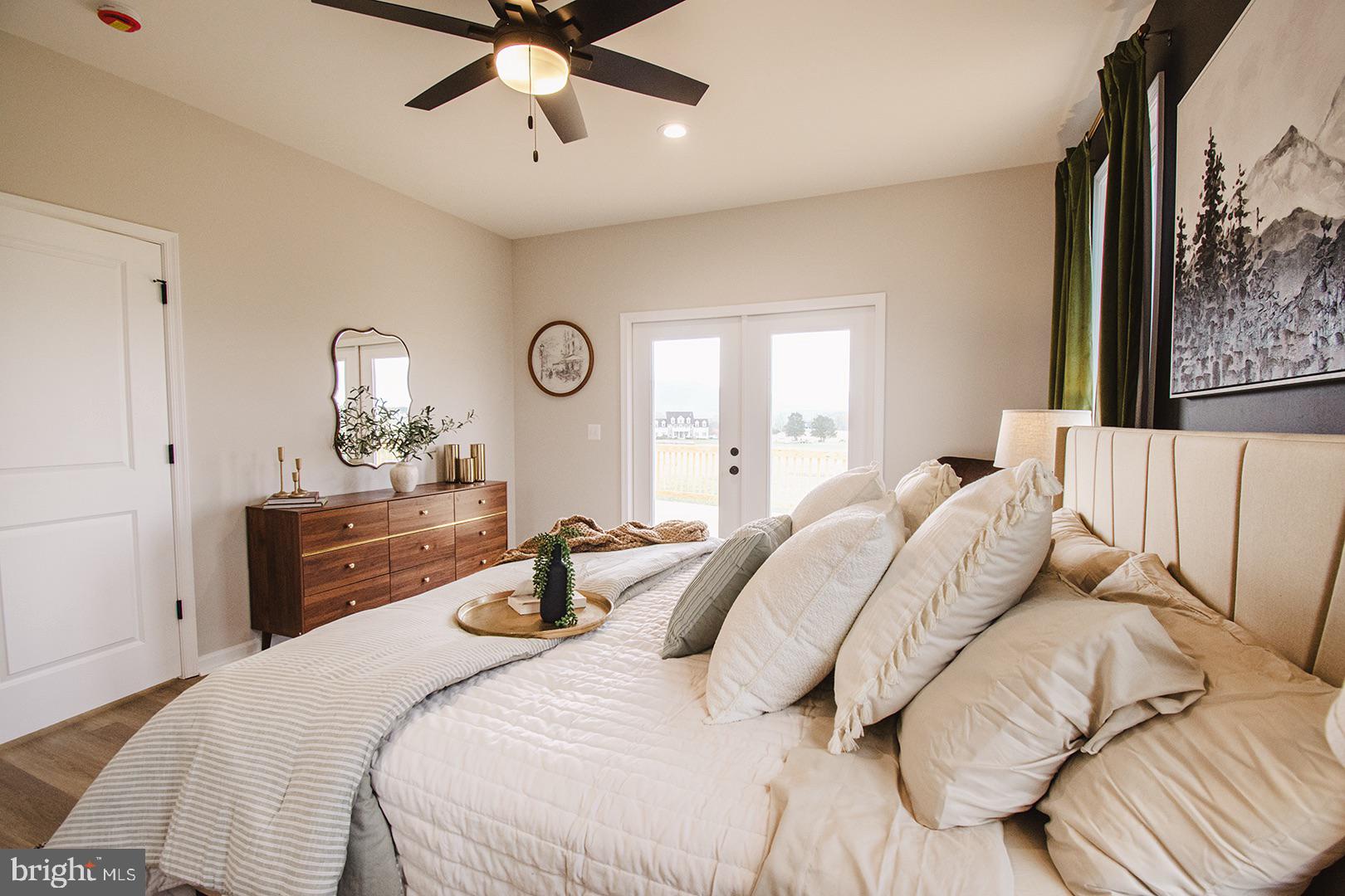 362 Drummer Hill Road Front Royal, VA 22630 - Photo 24 of 48 a bedroom with a large bed and a chandelier