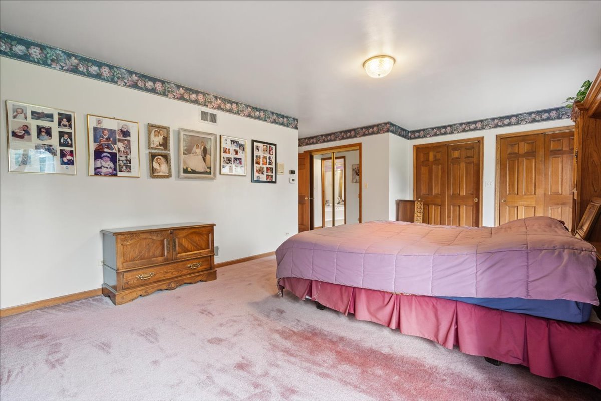 703 Newcastle Lane Prospect Heights, IL 60070 - Photo 23 of 45 a bedroom with a bed and a large window