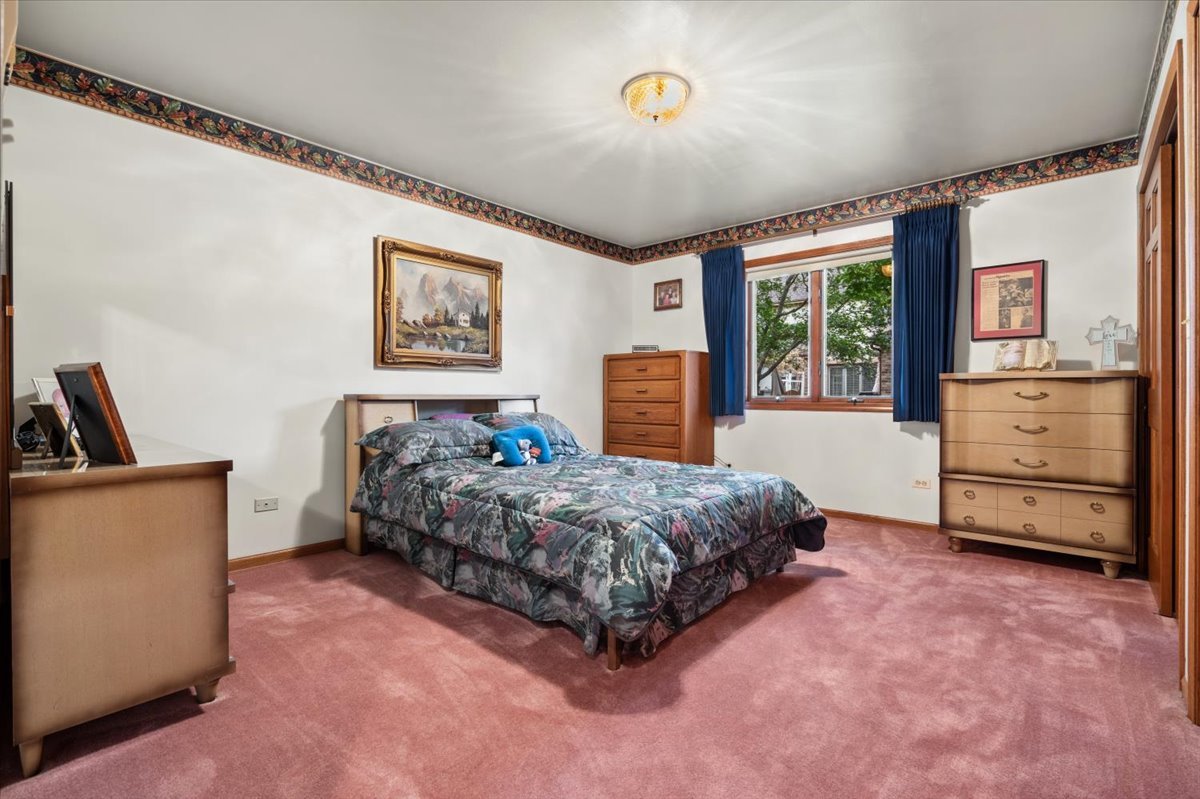 703 Newcastle Lane Prospect Heights, IL 60070 - Photo 30 of 45 a spacious bedroom with a bed and a cabinets