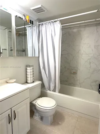 a spacious bedroom with a bed and a couch