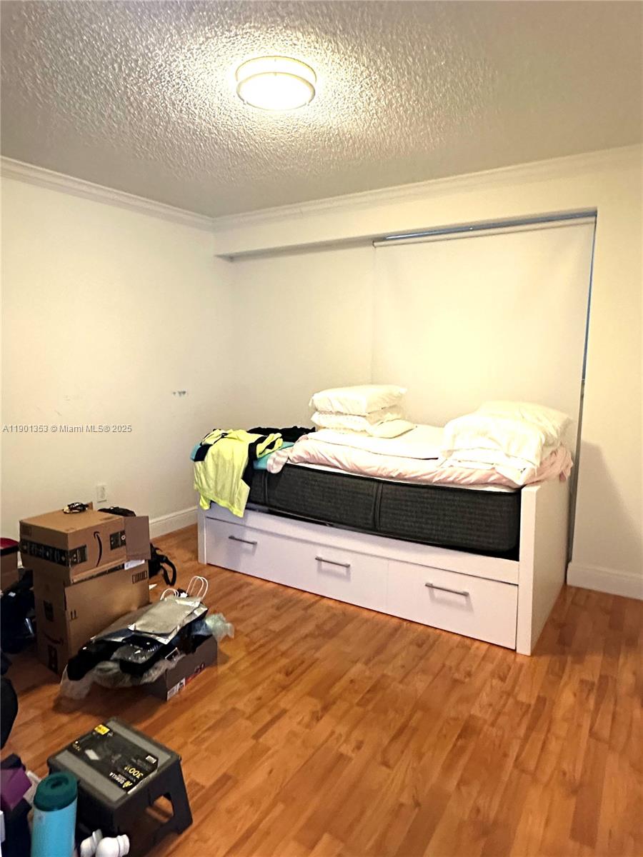 199 Southwest 12th Avenue, Unit 519B Miami, FL 33130 - Photo 13 of 25 a living room with a bed and a flat screen tv