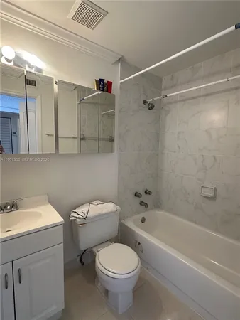 a bathroom with a sink mirror and toilet