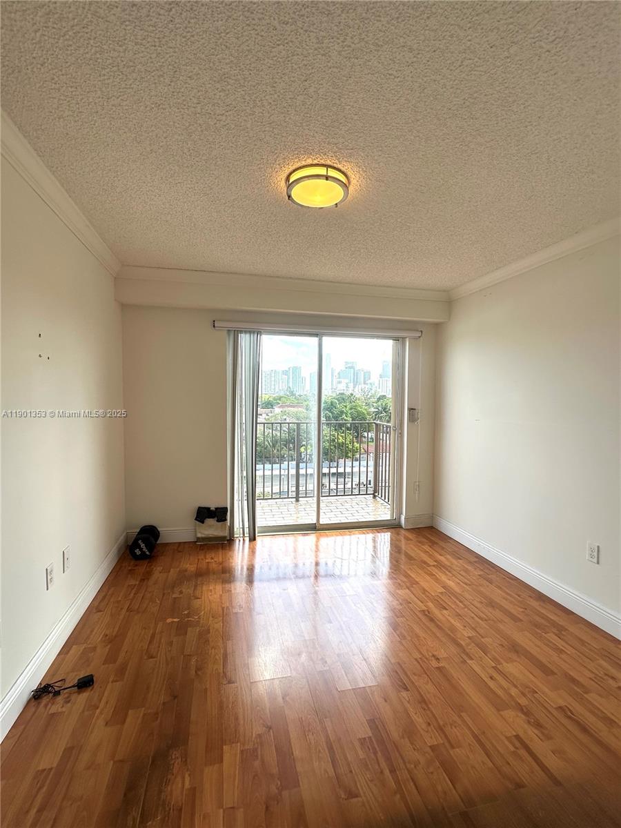 199 Southwest 12th Avenue, Unit 519B Miami, FL 33130 - Photo 15 of 25 a view of empty room with wooden floor and fan