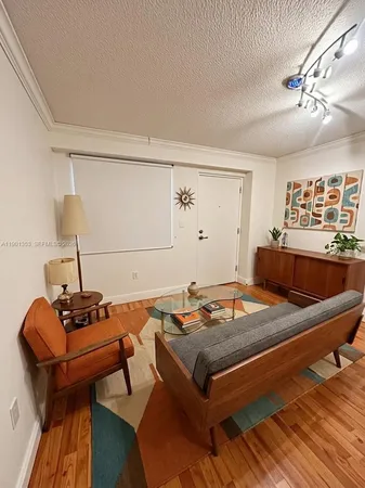a kitchen with a sink a refrigerator and white cabinets