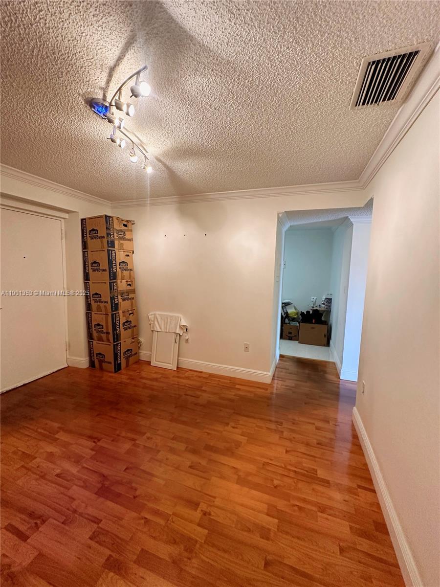 199 Southwest 12th Avenue, Unit 519B Miami, FL 33130 - Photo 6 of 25 a view of an empty room with wooden floor