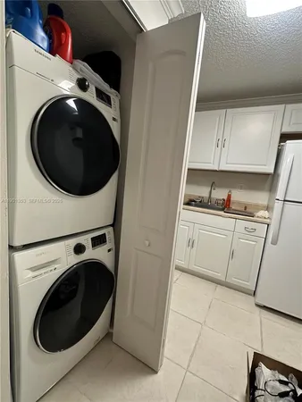 a white stove top oven sitting inside of a kitchen