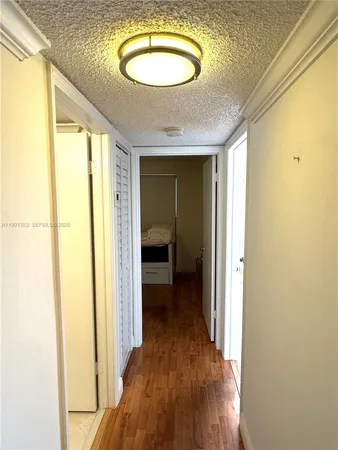 a room with a bed and wooden floor