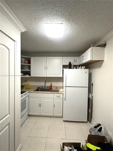 a white stove top oven sitting inside of a kitchen