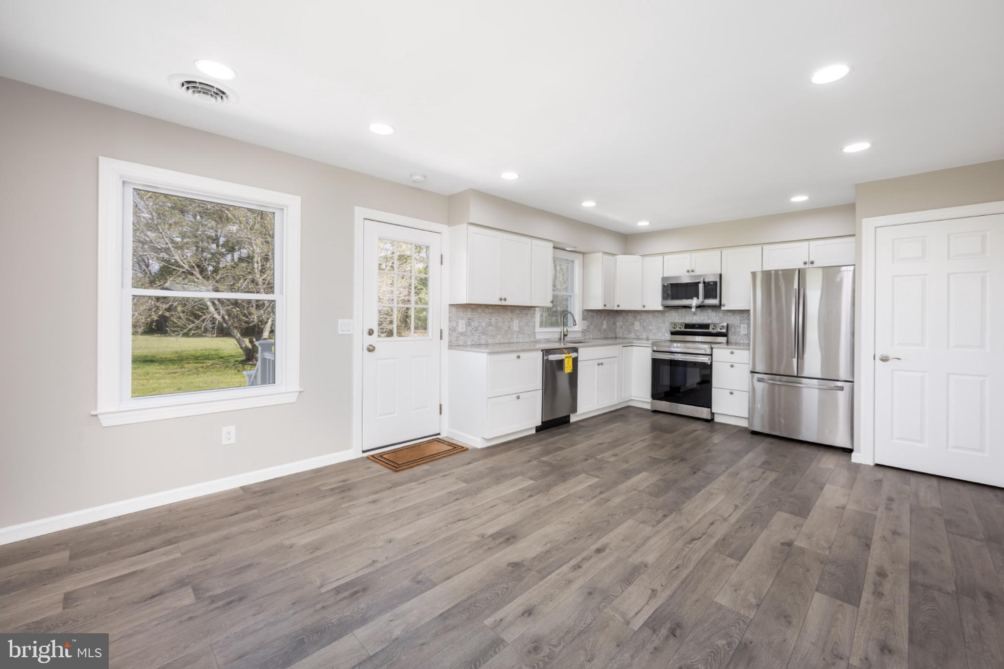 7121 Cedartown Road Snow Hill, MD 21863 - Photo 13 of 52 a kitchen with wooden floors and refrigerator