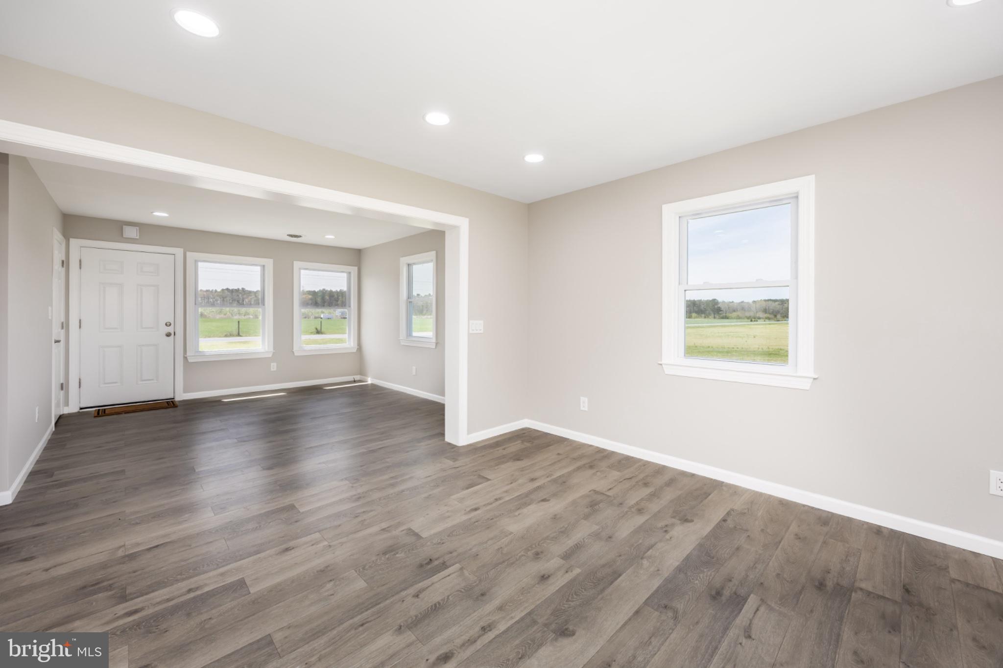 7121 Cedartown Road Snow Hill, MD 21863 - Photo 15 of 52 an empty room with wooden floor and windows