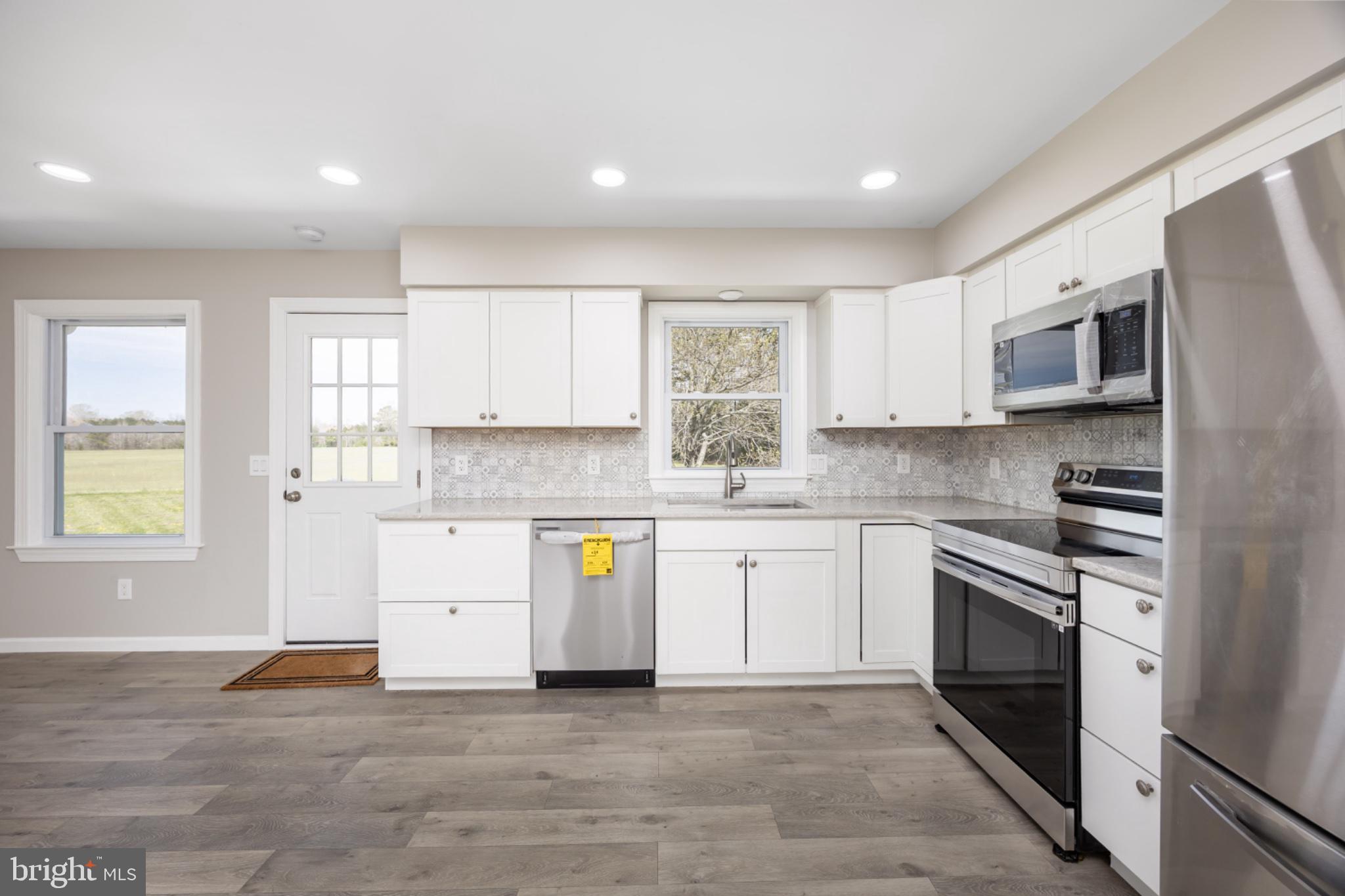 7121 Cedartown Road Snow Hill, MD 21863 - Photo 16 of 52 a kitchen with stainless steel appliances granite countertop a stove a sink and a microwave