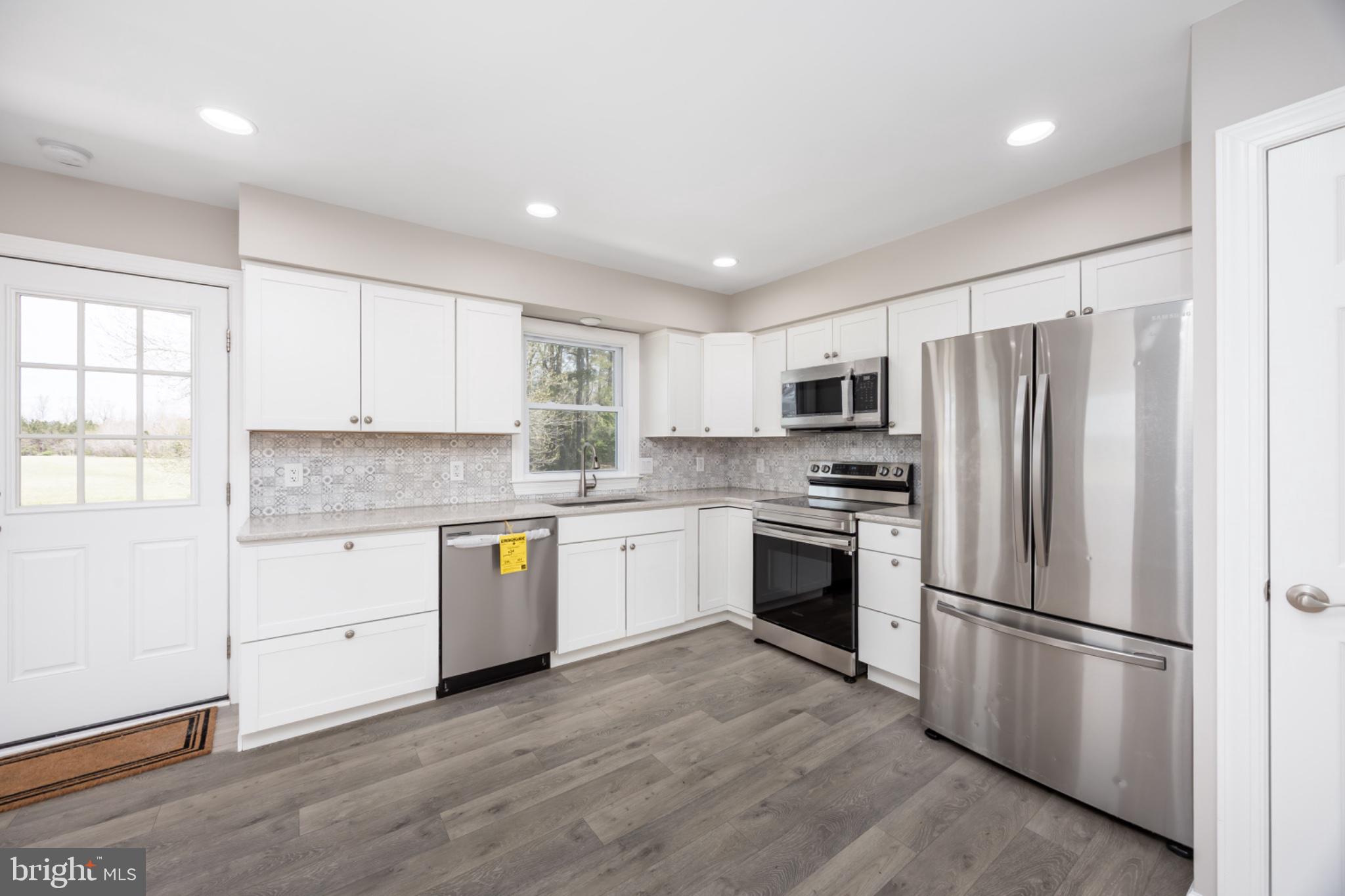 7121 Cedartown Road Snow Hill, MD 21863 - Photo 17 of 52 a kitchen with a refrigerator cabinets stainless steel appliances and a window