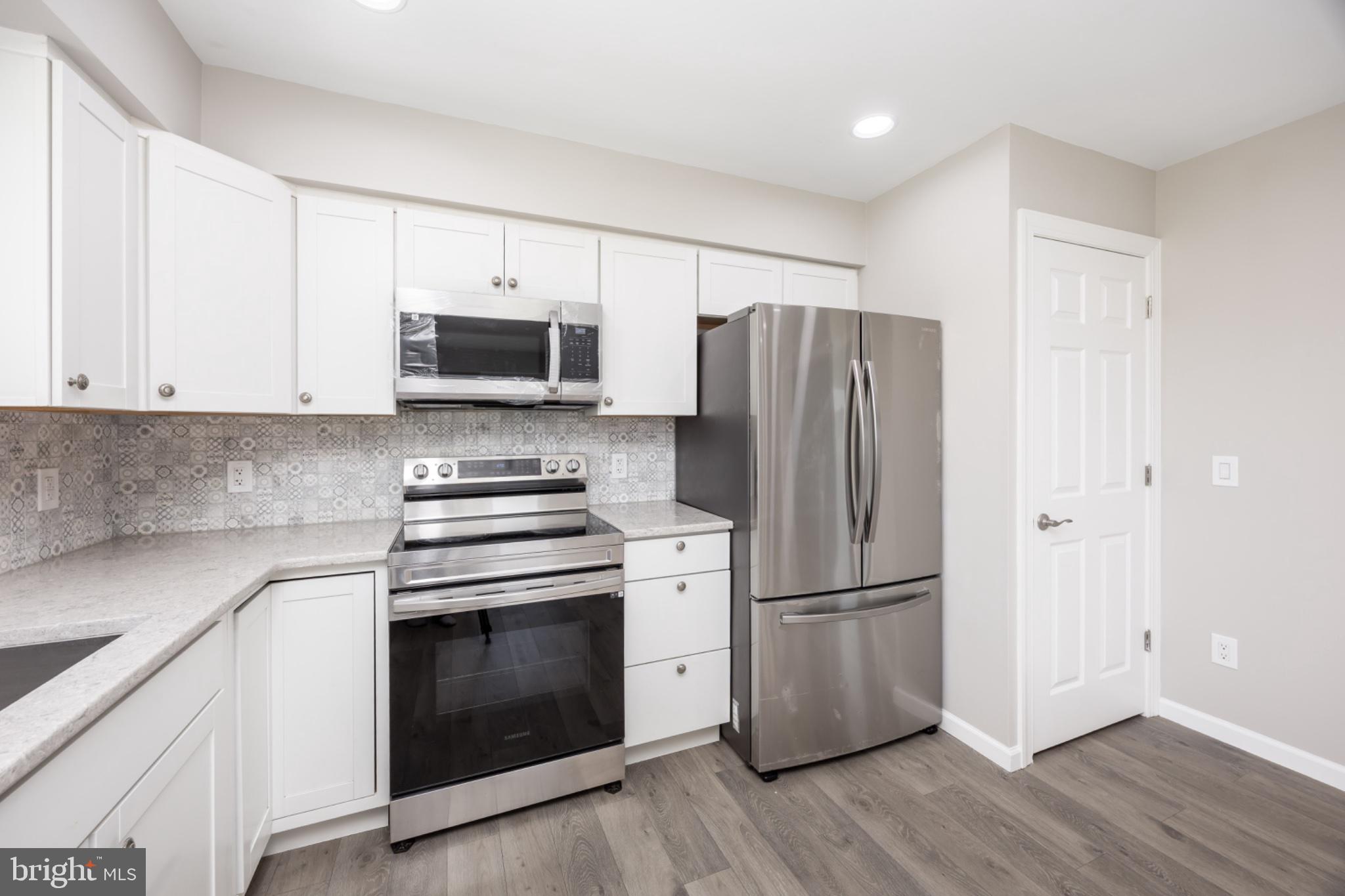 7121 Cedartown Road Snow Hill, MD 21863 - Photo 20 of 52 a kitchen with a stove a refrigerator and a microwave