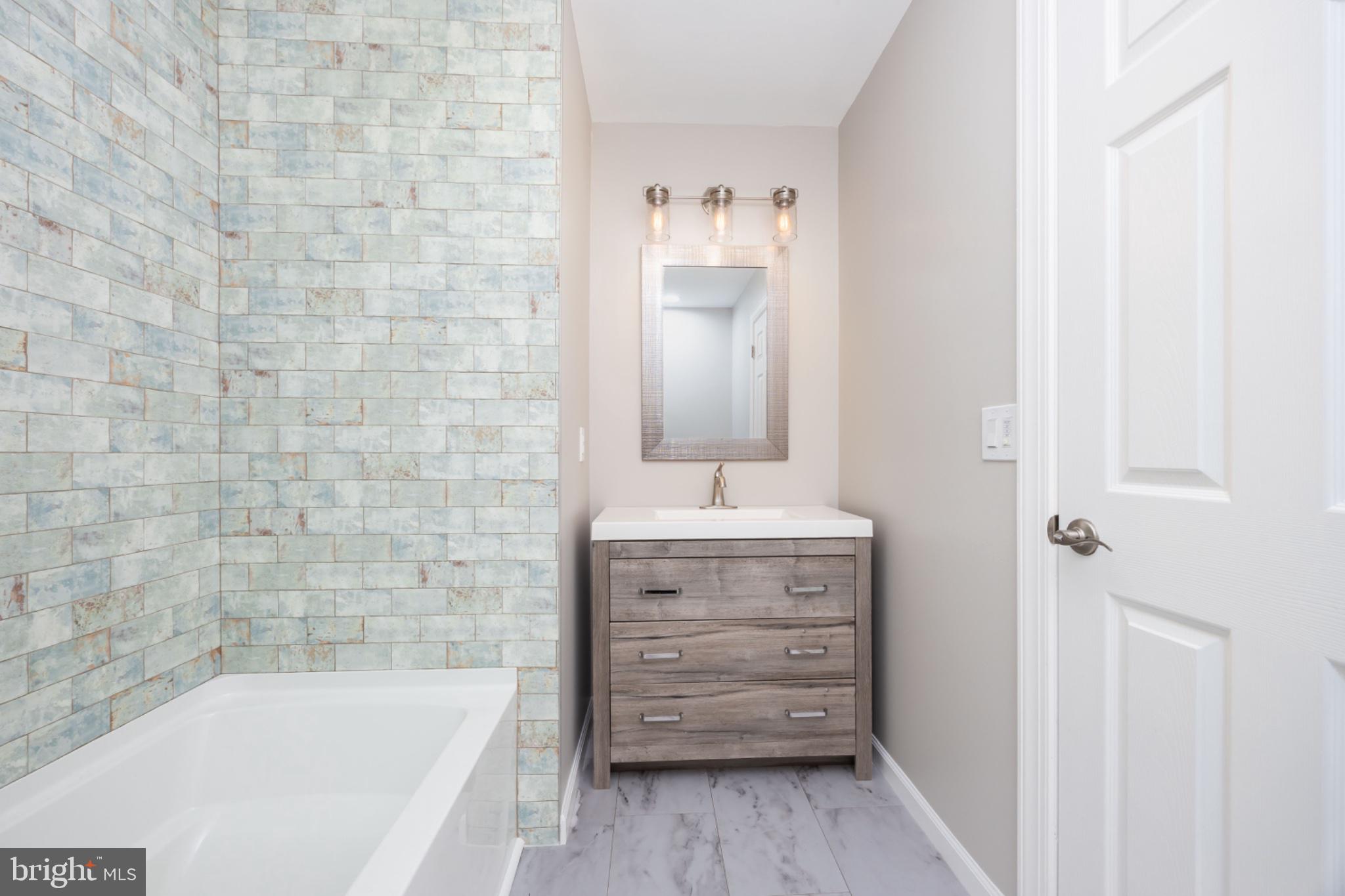 7121 Cedartown Road Snow Hill, MD 21863 - Photo 27 of 52 a bathroom with a bathtub and a sink