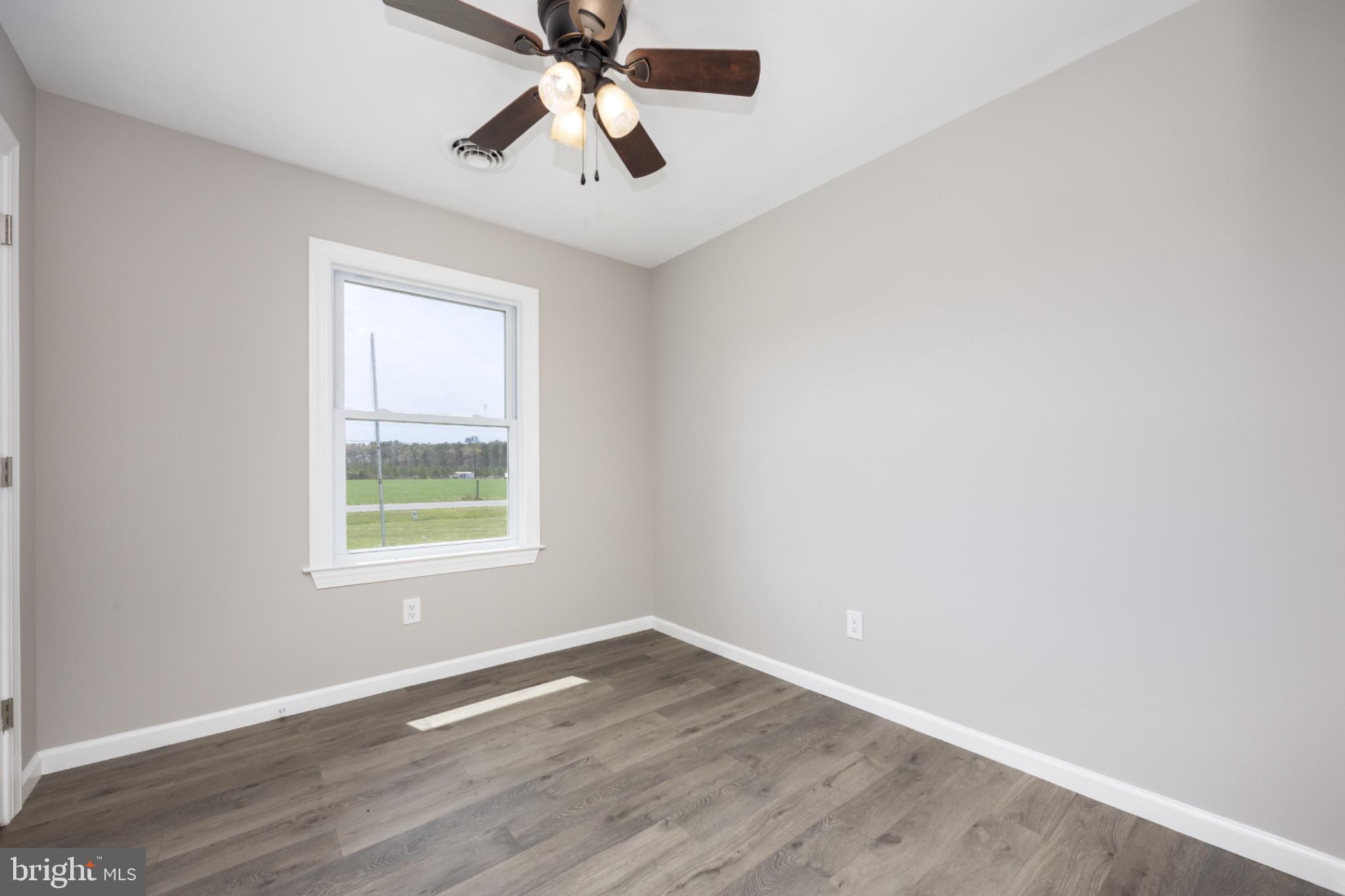 7121 Cedartown Road Snow Hill, MD 21863 - Photo 30 of 52 an empty room with a window and a fan