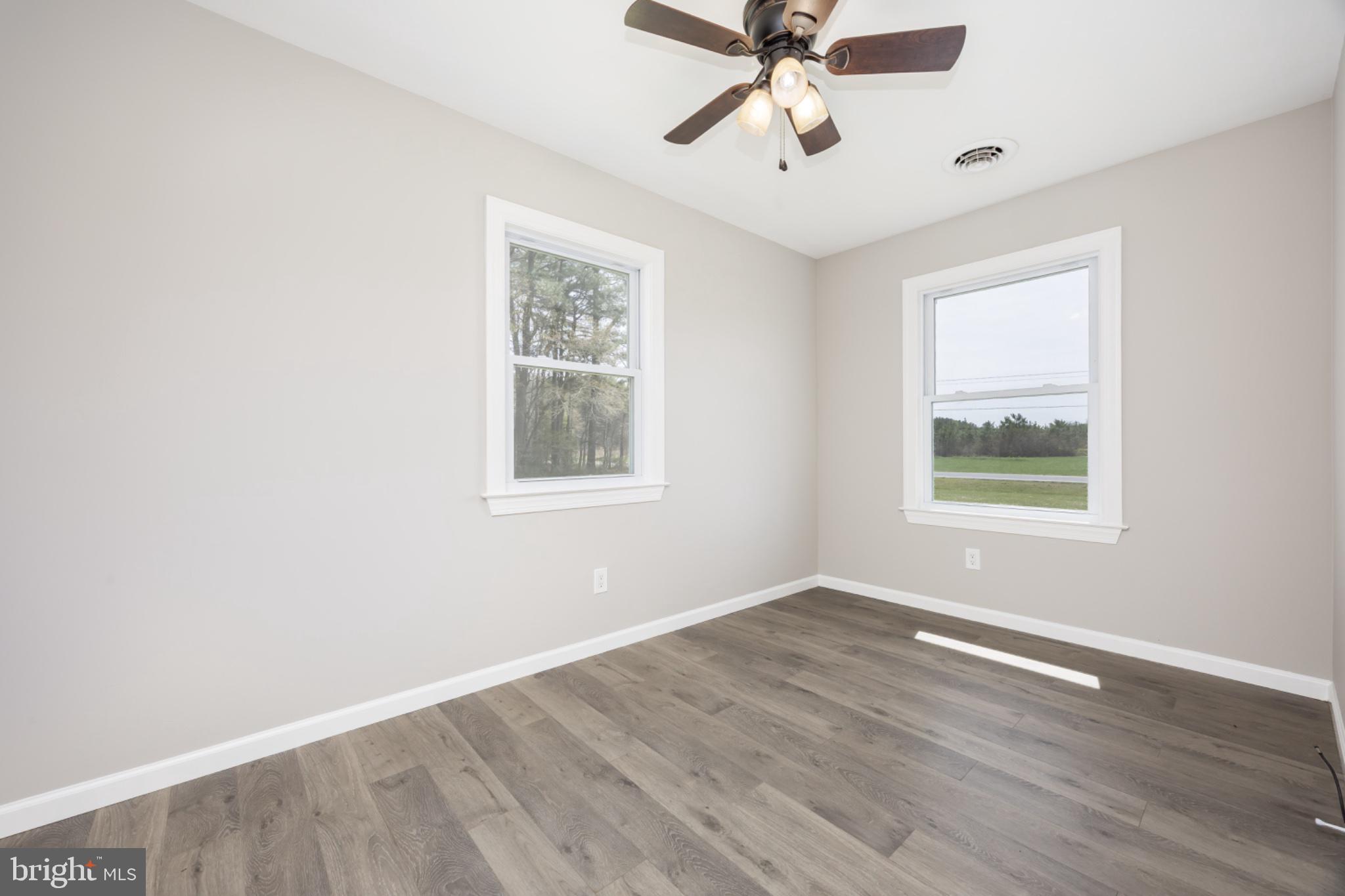 7121 Cedartown Road Snow Hill, MD 21863 - Photo 42 of 52 a view of an empty room with wooden floor and a window