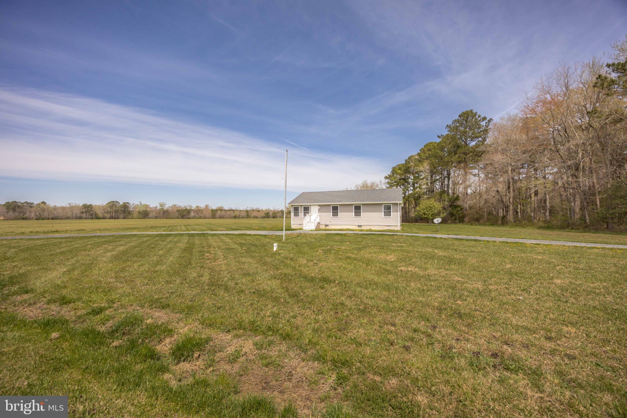 7121 Cedartown Road Snow Hill, MD 21863 - Photo 5 of 52 a front view of a house with a yard