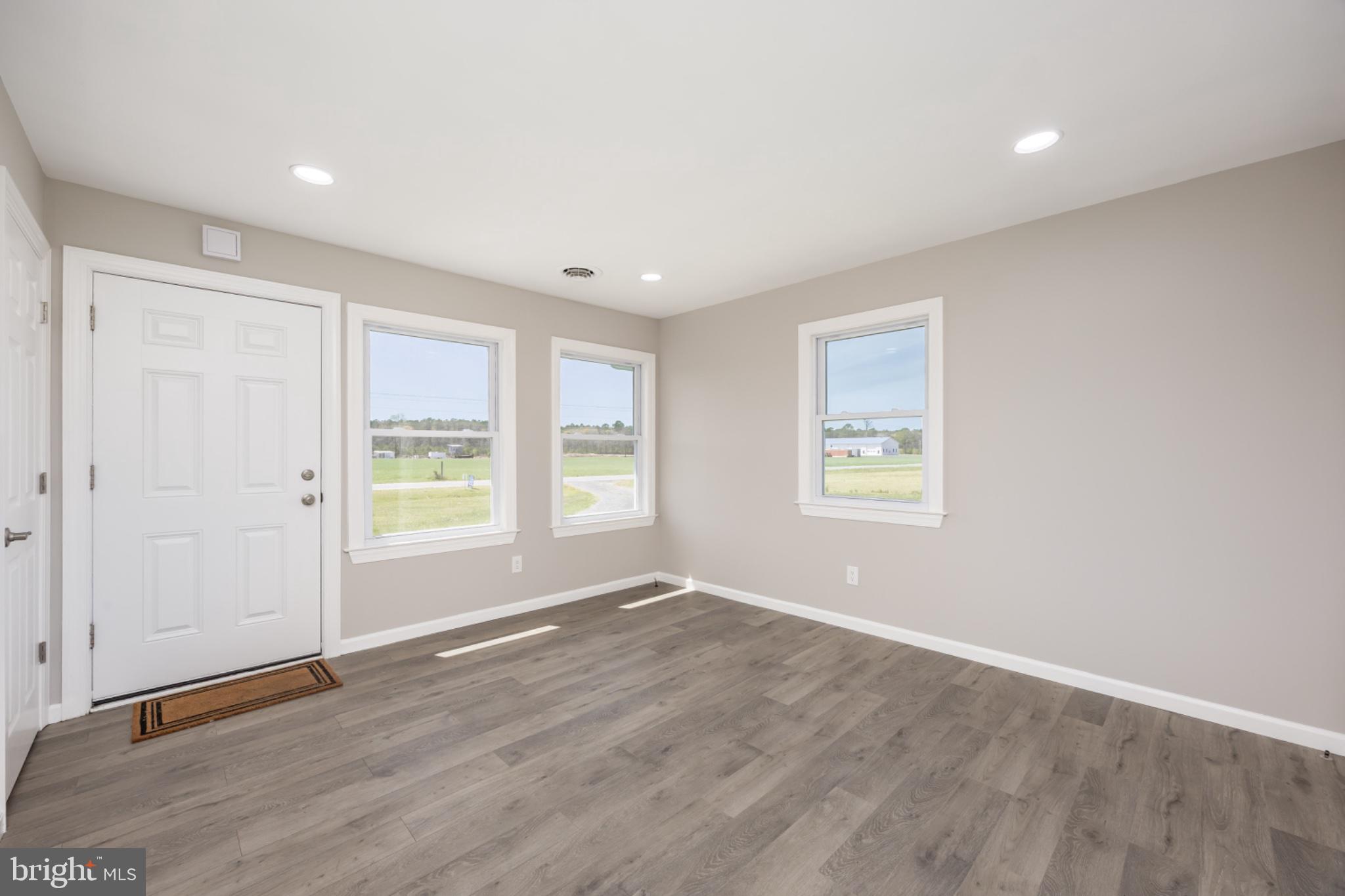 7121 Cedartown Road Snow Hill, MD 21863 - Photo 10 of 52 an empty room with wooden floor and windows
