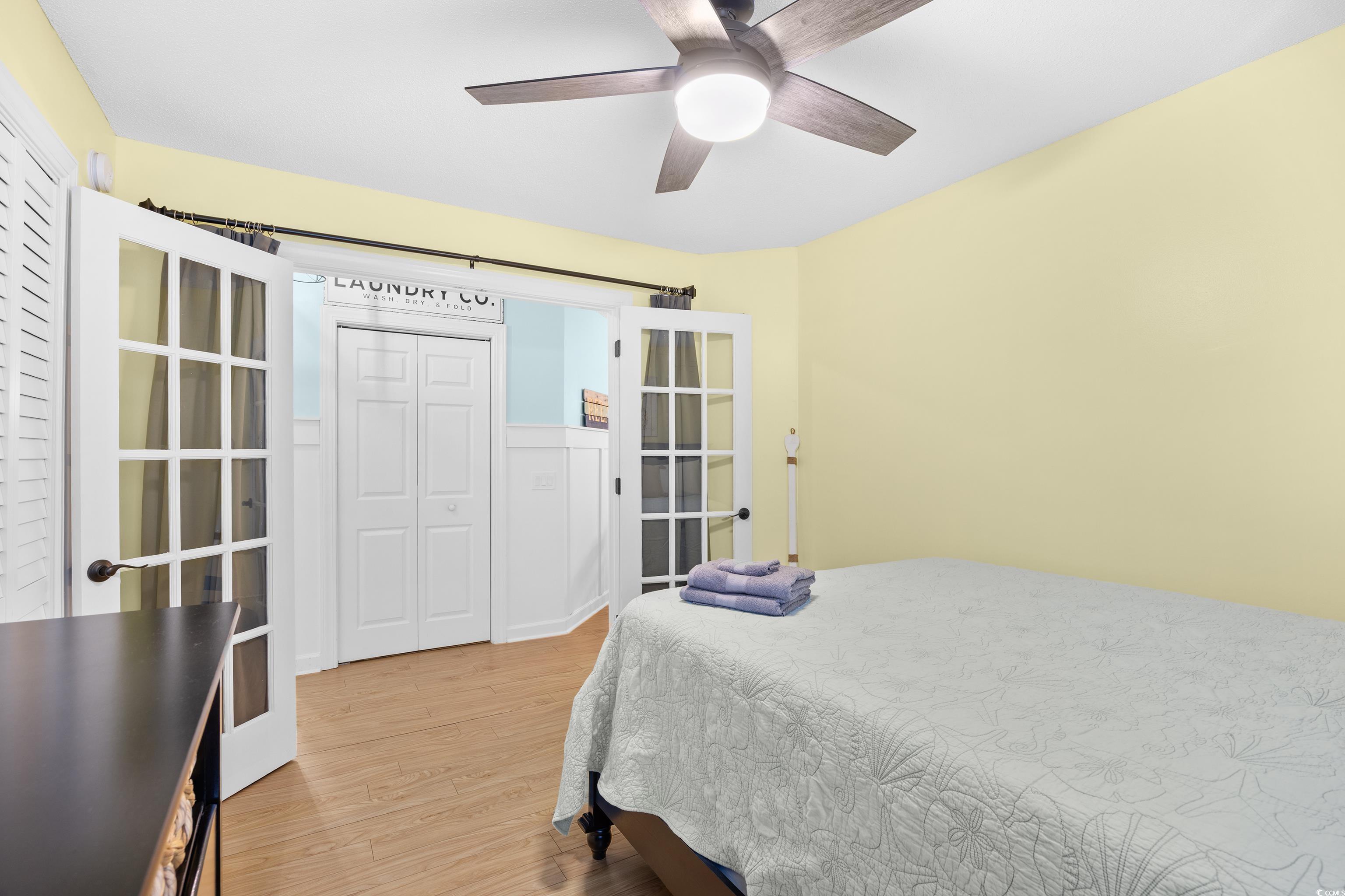 4277 Santolina Way, Unit D Murrells Inlet, SC 29576 - Photo 15 of 40 Bedroom with french doors, light wood-type flooring, and ceiling fan