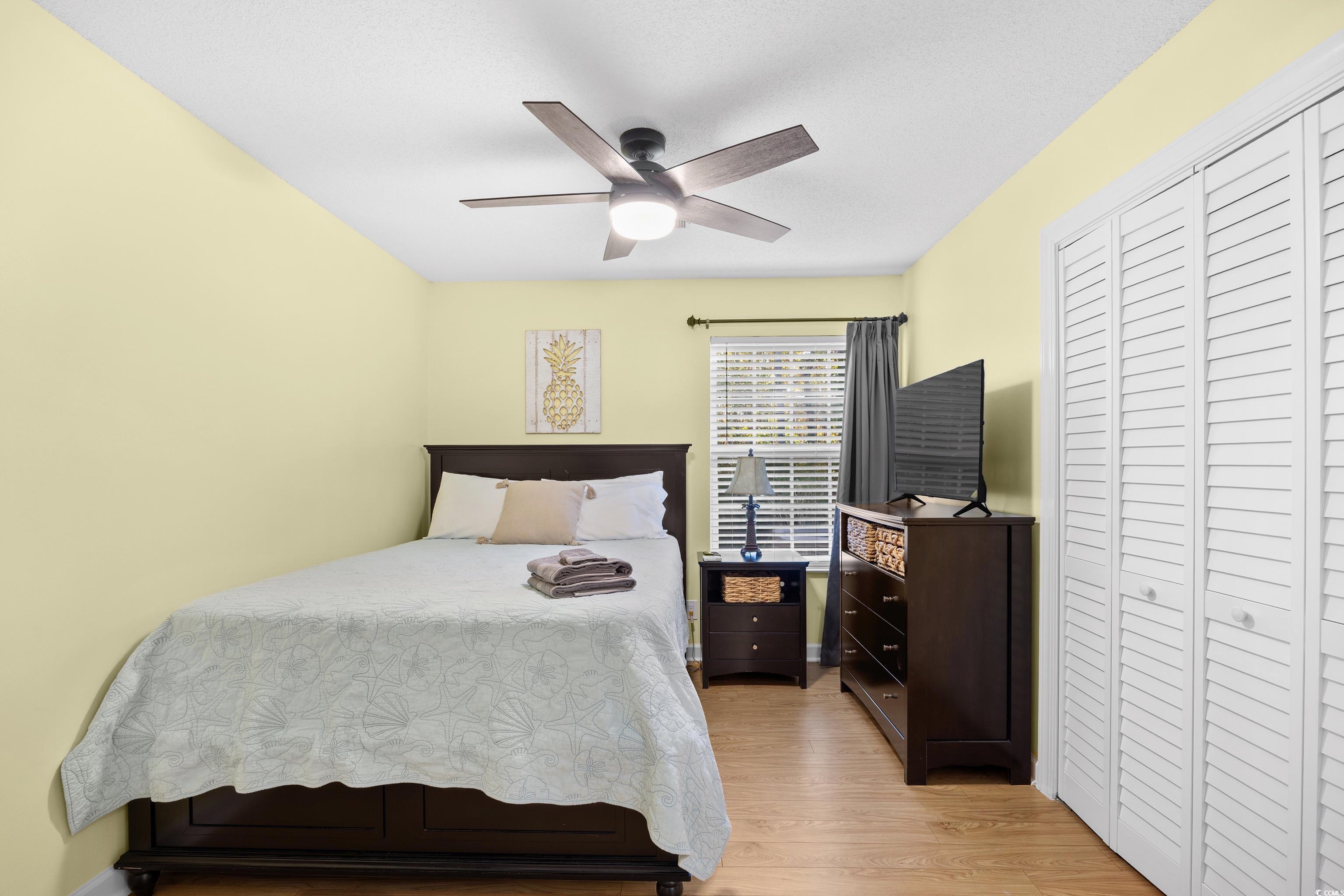 4277 Santolina Way, Unit D Murrells Inlet, SC 29576 - Photo 16 of 40 Bedroom with a closet, light wood-style floors, and ceiling fan