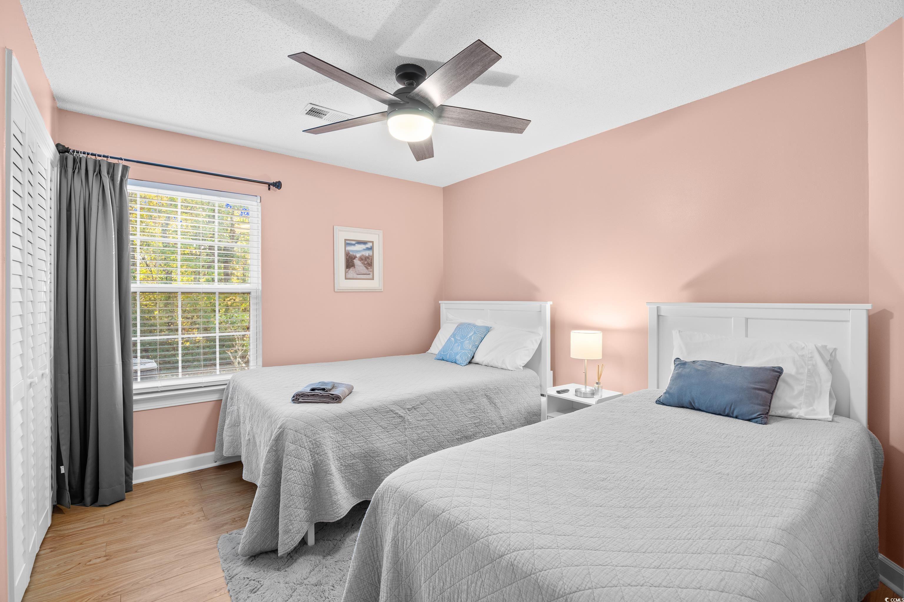 4277 Santolina Way, Unit D Murrells Inlet, SC 29576 - Photo 18 of 40 Bedroom featuring light wood-style floors, ceiling fan, and a textured ceiling