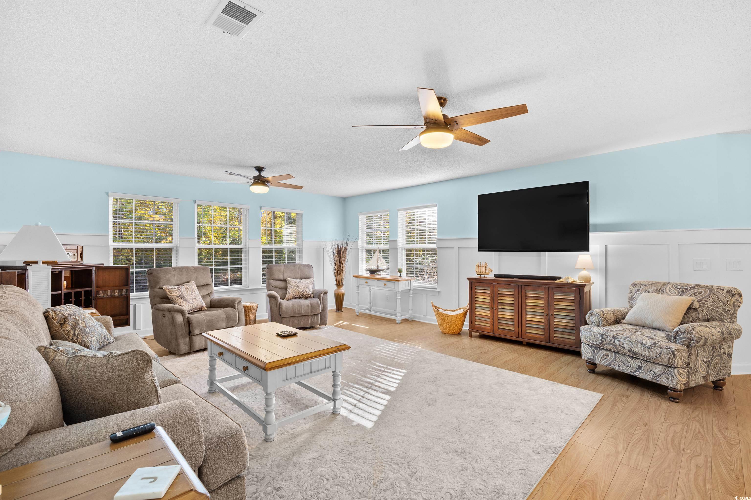4277 Santolina Way, Unit D Murrells Inlet, SC 29576 - Photo 2 of 40 Living area with a wainscoted wall, light wood-type flooring, healthy amount of natural light, a ceiling fan, and a textured ceiling