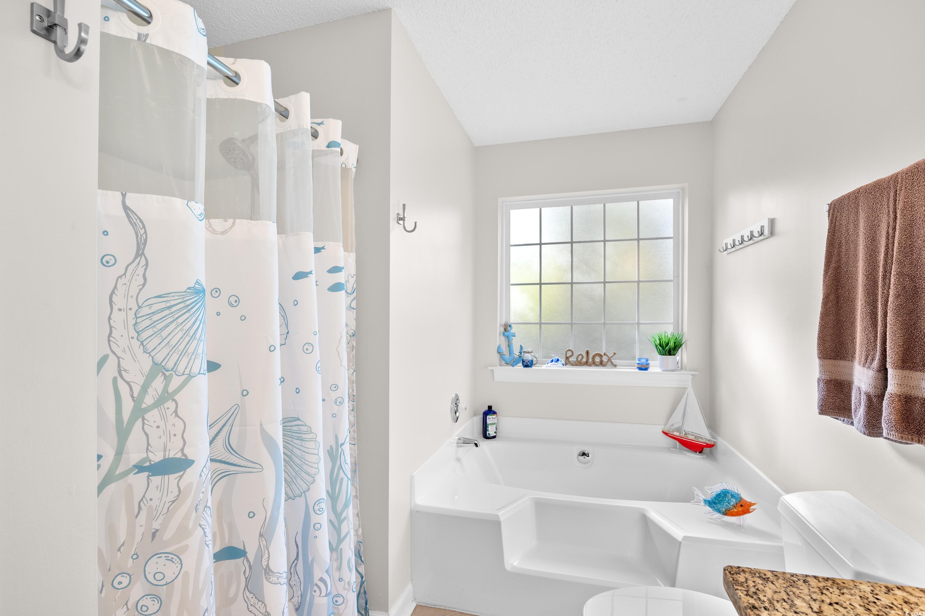 4277 Santolina Way, Unit D Murrells Inlet, SC 29576 - Photo 26 of 40 Bathroom with a bath and a stall shower