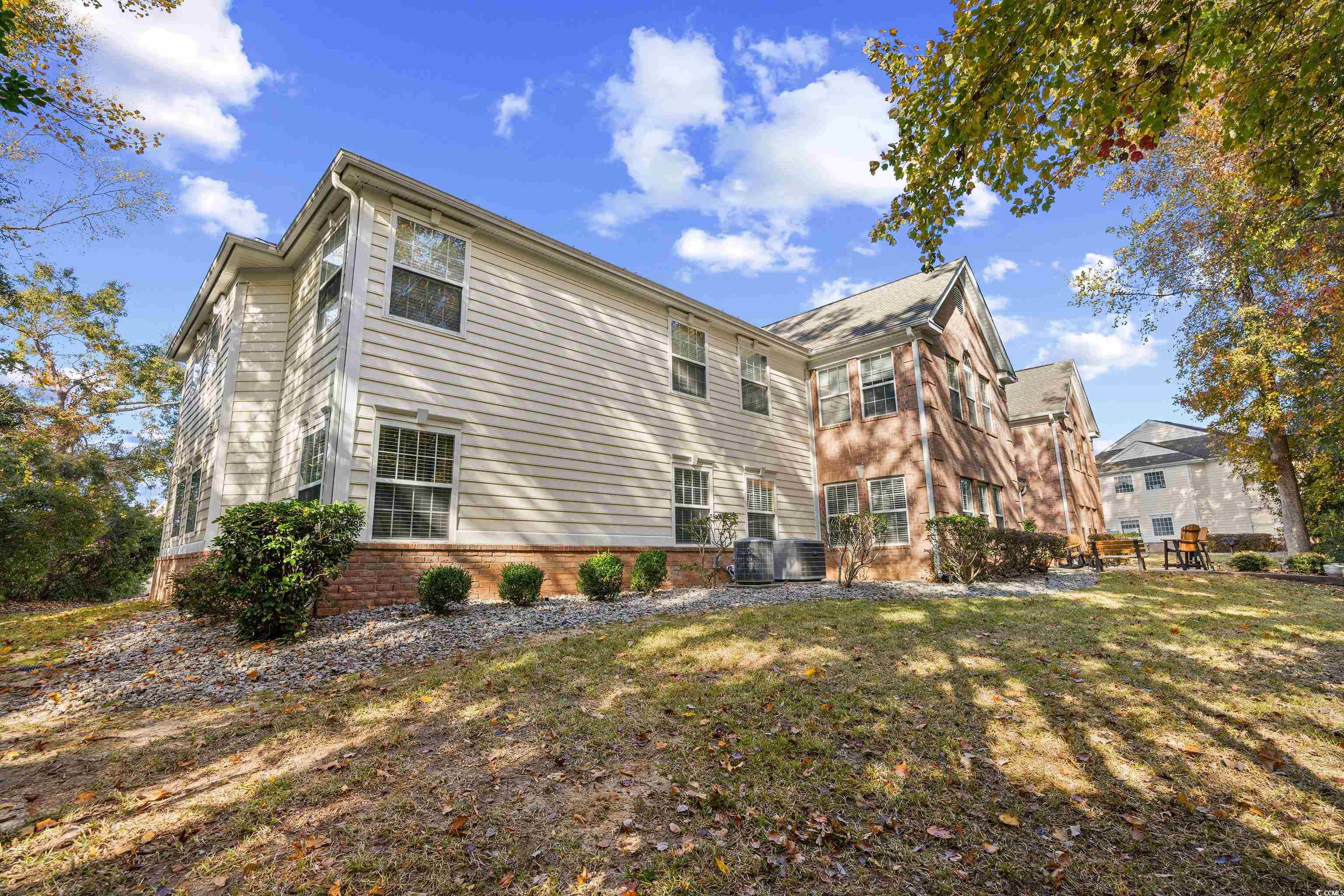 4277 Santolina Way, Unit D Murrells Inlet, SC 29576 - Photo 31 of 40 Back of property with a lawn and brick siding