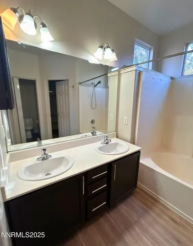 a bathroom with a sink double vanity and a mirror
