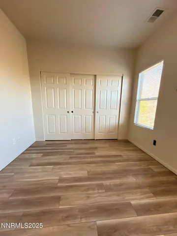 a view of wooden floor and windows in a room